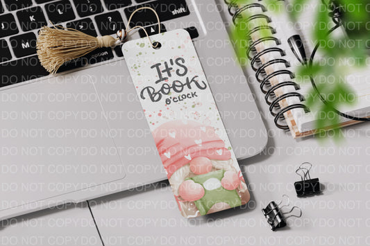 a bookmark on a laptop next to a plant