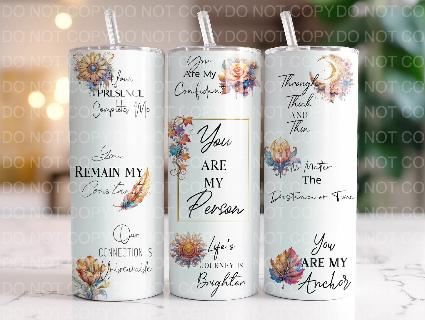 three white candles with floral designs on them