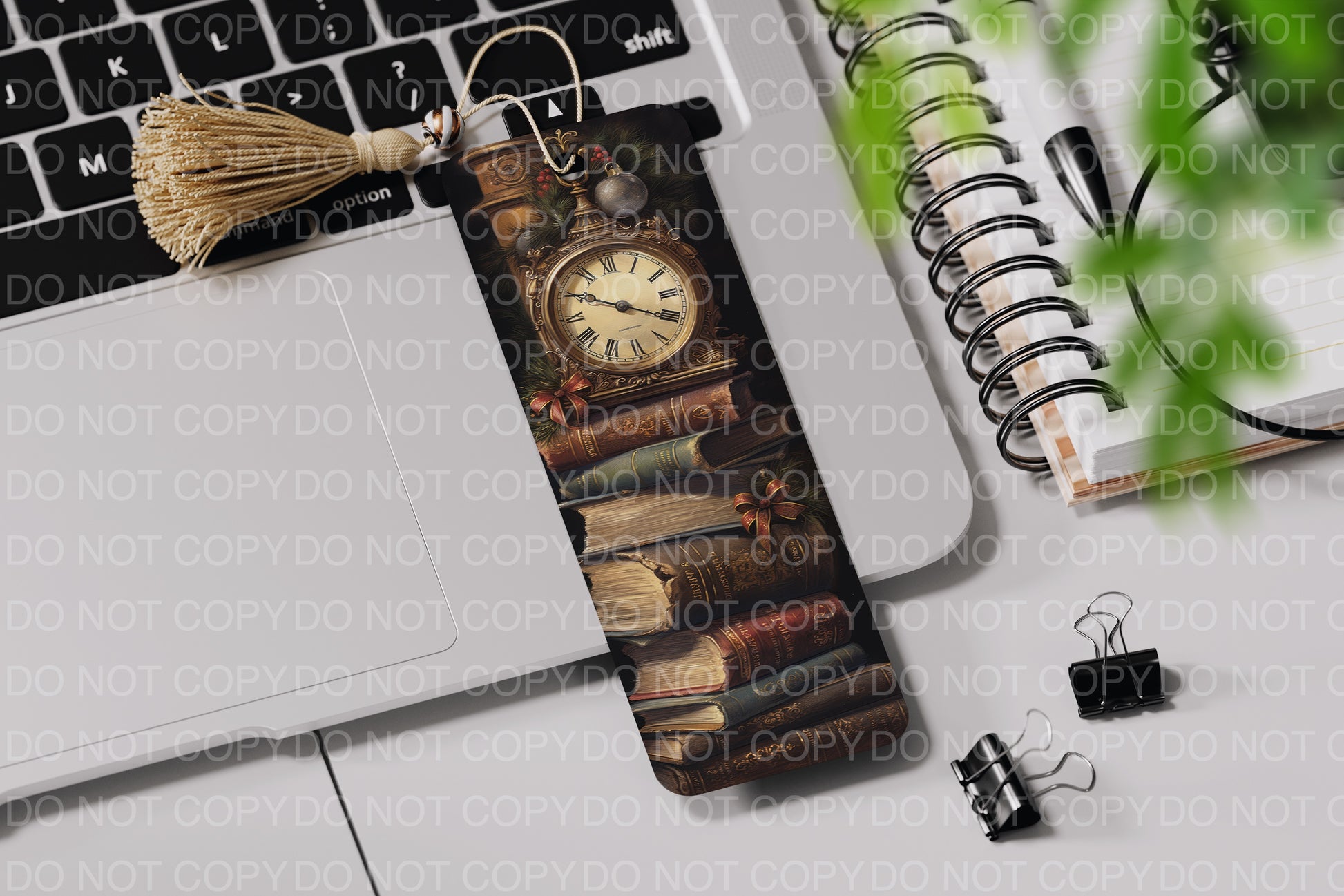 a bookmark with a clock on it next to a laptop