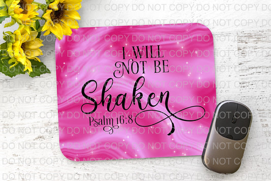 a pink mouse pad with the words i will not be shaken